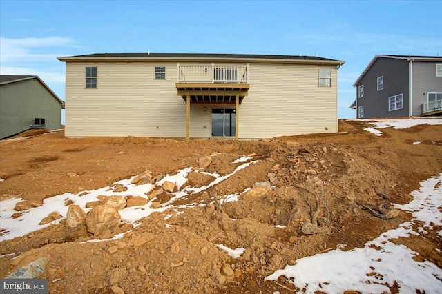 view of snow covered rear of property