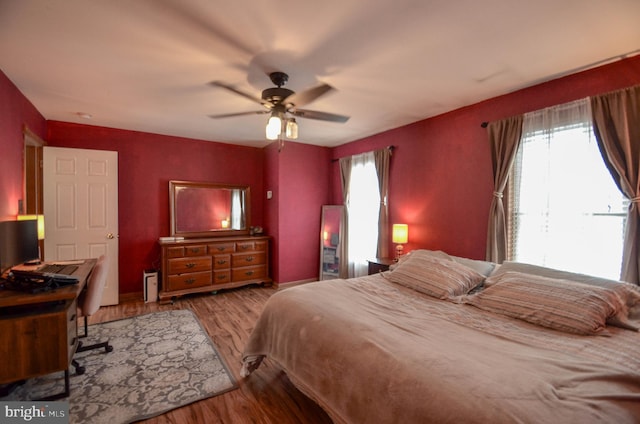 bedroom with ceiling fan and light hardwood / wood-style floors