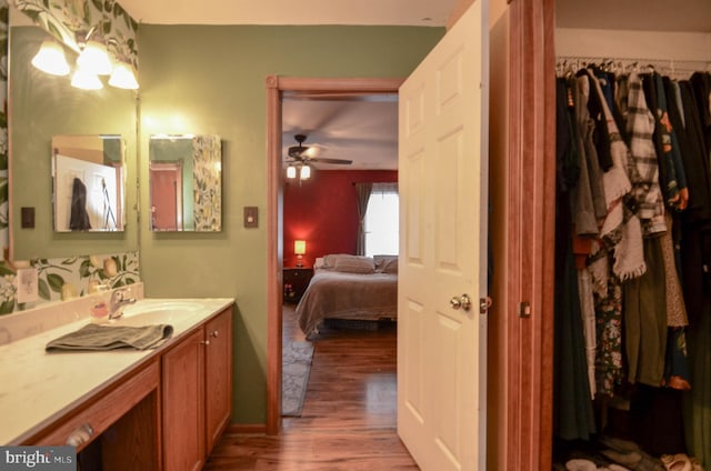 bathroom with ceiling fan, wood-type flooring, and vanity