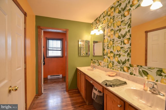 bathroom with a baseboard radiator, wood-type flooring, and vanity