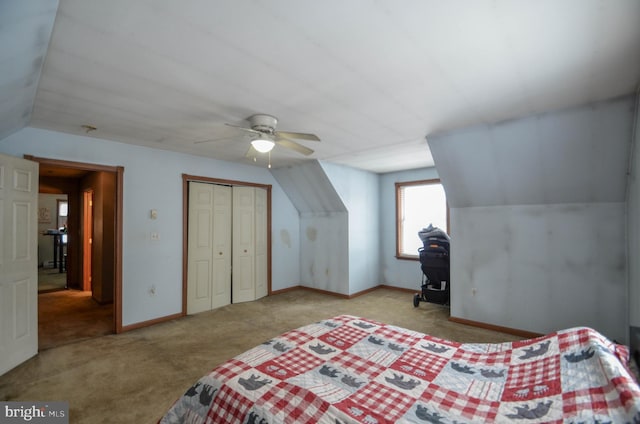 bedroom featuring ceiling fan, light colored carpet, a closet, and lofted ceiling