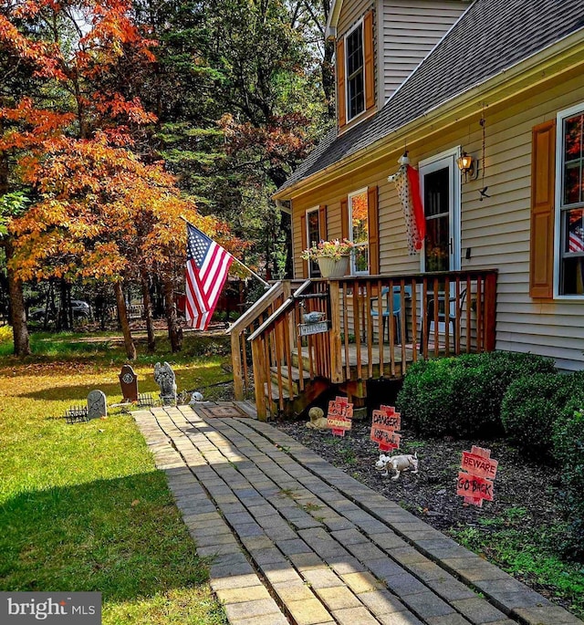 wooden terrace with a yard