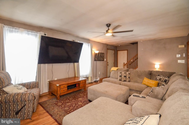 living room with ceiling fan and light hardwood / wood-style floors