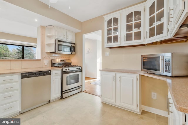 kitchen with ceiling fan, white cabinets, and appliances with stainless steel finishes