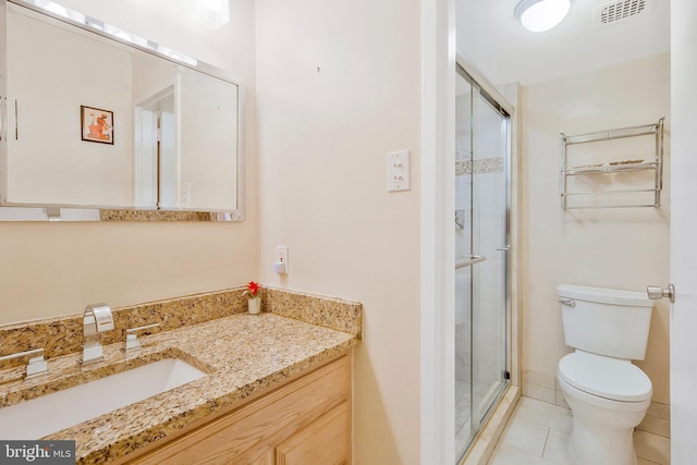 bathroom with toilet, walk in shower, vanity, and tile patterned flooring