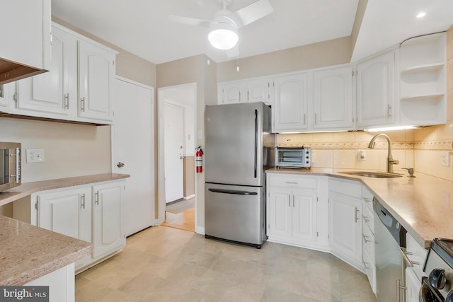 kitchen featuring ceiling fan, white cabinets, appliances with stainless steel finishes, and sink