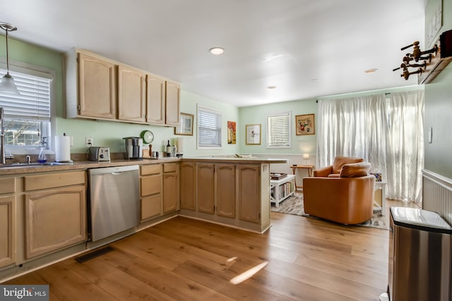 kitchen with decorative light fixtures, light wood-type flooring, dishwasher, and light brown cabinetry