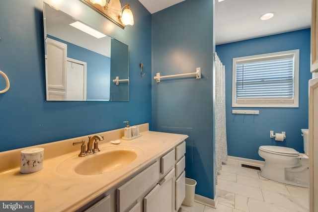 bathroom with toilet and vanity