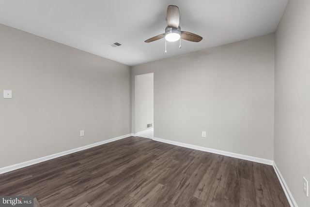 spare room featuring dark wood-type flooring and ceiling fan