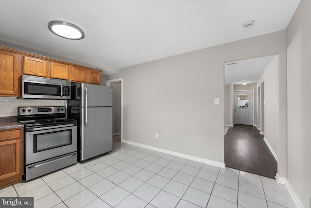 kitchen with appliances with stainless steel finishes and light tile patterned floors