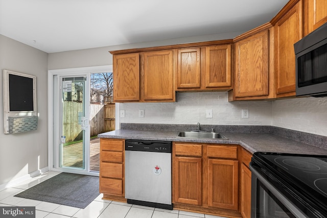 kitchen with sink, light tile patterned floors, and stainless steel appliances