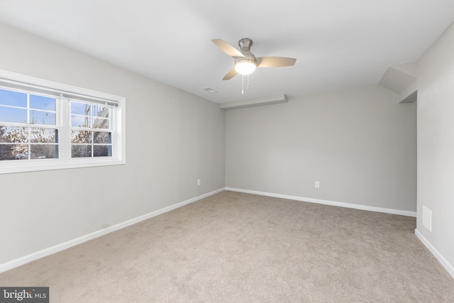 spare room featuring light colored carpet and ceiling fan