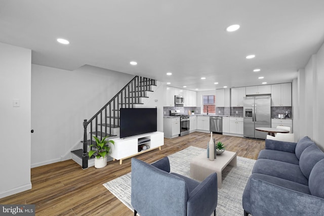 living room featuring sink and hardwood / wood-style floors