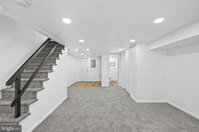 basement with carpet and electric panel