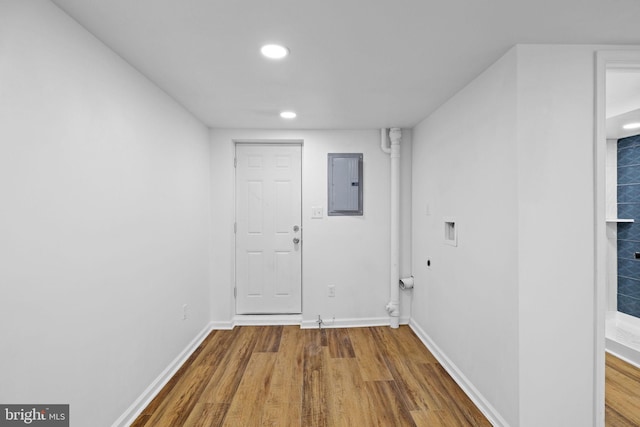 hallway with wood-type flooring and electric panel