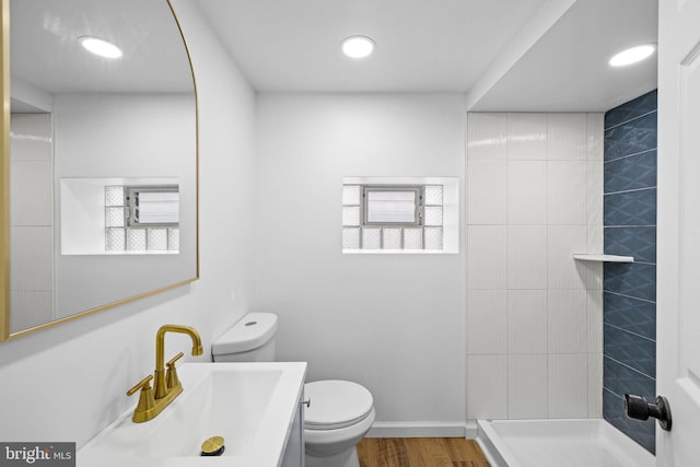 bathroom featuring plenty of natural light, hardwood / wood-style floors, toilet, and vanity