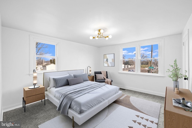 bedroom with carpet flooring and a notable chandelier