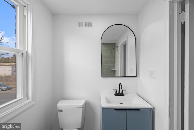 bathroom featuring toilet and vanity