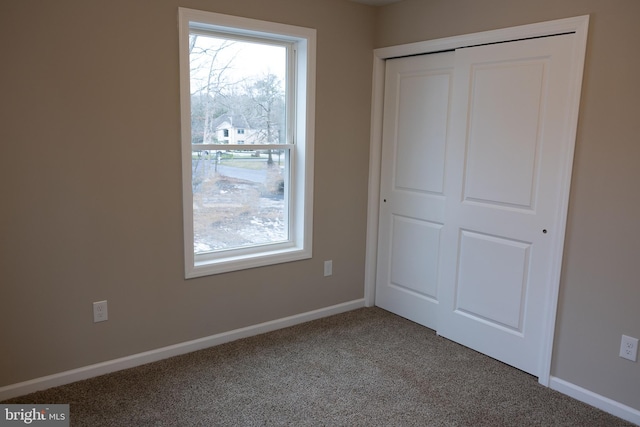 unfurnished bedroom with carpet and a closet