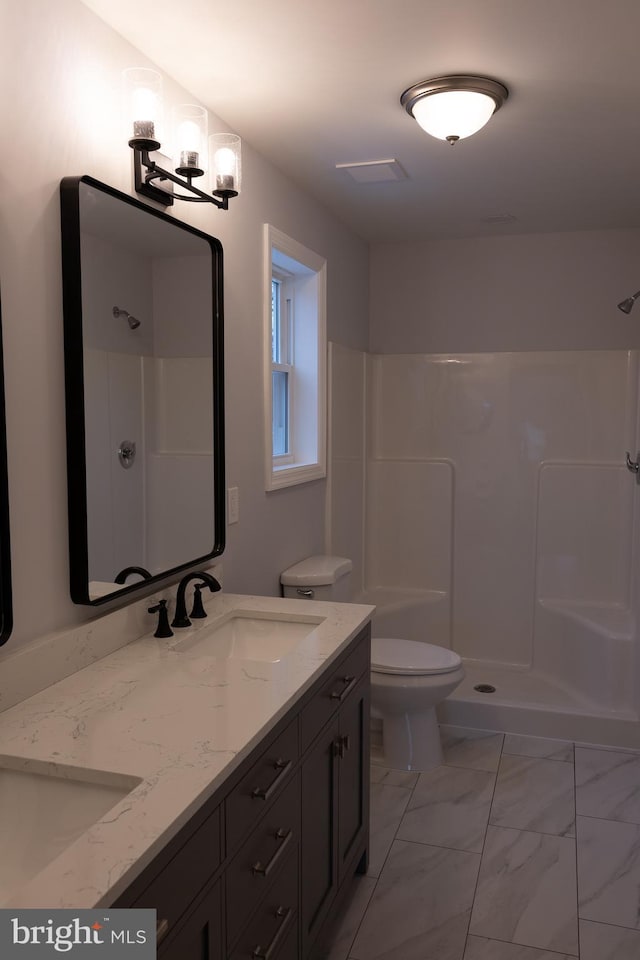 bathroom featuring toilet, an inviting chandelier, a shower, and vanity