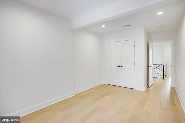 interior space with light hardwood / wood-style floors and a closet