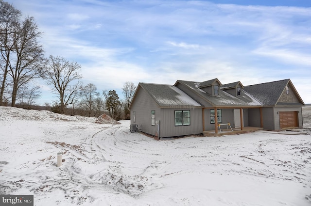 view of front of home featuring central AC unit and a garage