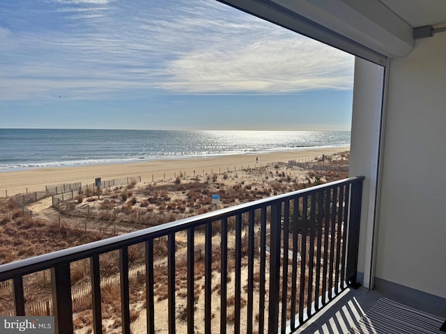 balcony with a view of the beach and a water view