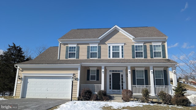 view of front of property with a porch and a garage