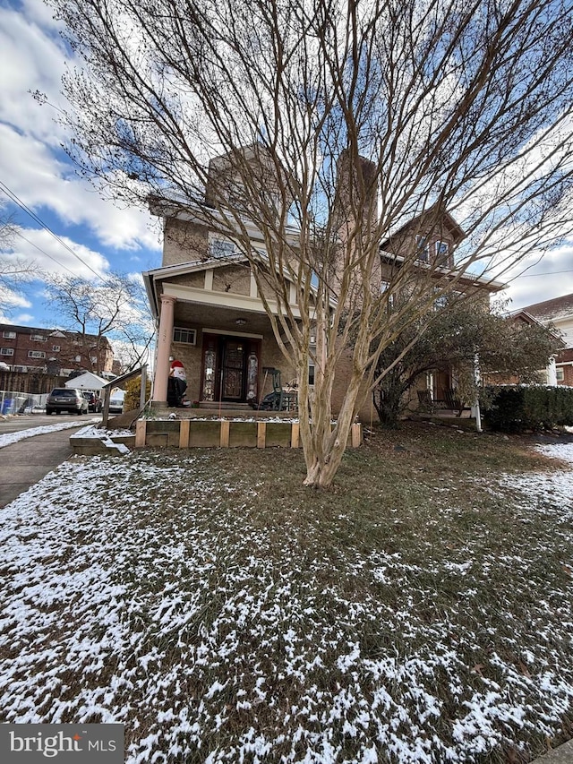 view of snow covered rear of property