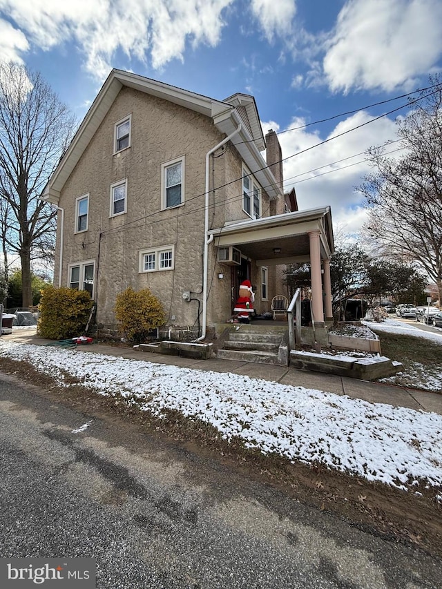 view of snowy exterior with a porch