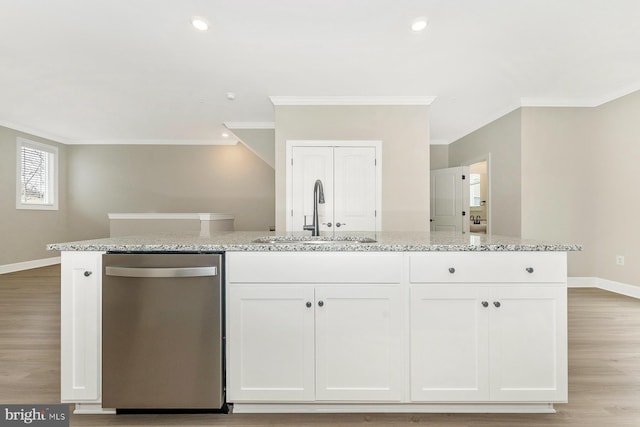 kitchen with an island with sink, dishwasher, sink, and white cabinetry