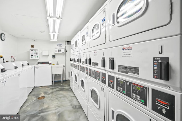 laundry area featuring stacked washer and dryer and washer and clothes dryer