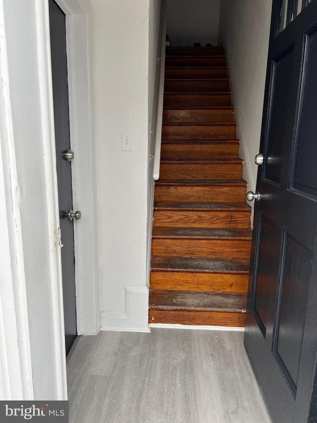 stairs with hardwood / wood-style floors