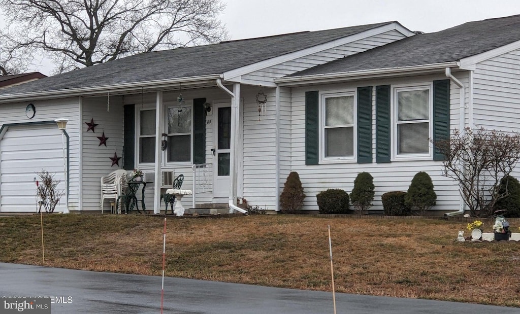 single story home featuring a garage and a front yard