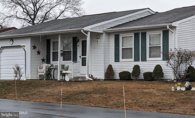 single story home featuring a garage and a front yard