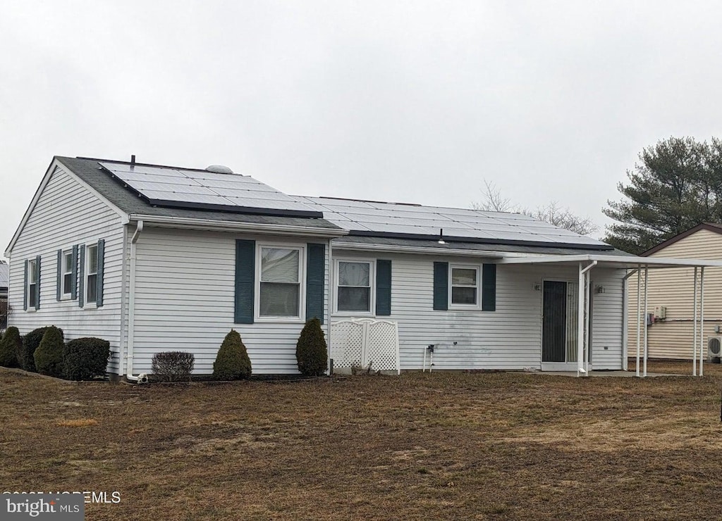 exterior space with a yard and solar panels