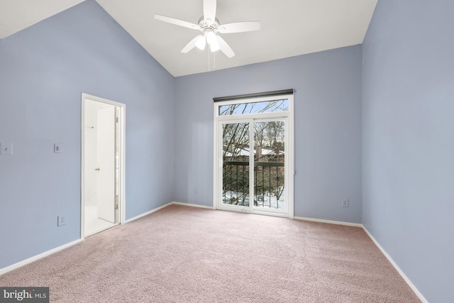 carpeted spare room with ceiling fan and high vaulted ceiling