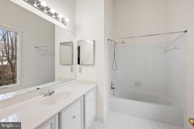 bathroom with tile patterned flooring, tiled shower / bath combo, and vanity