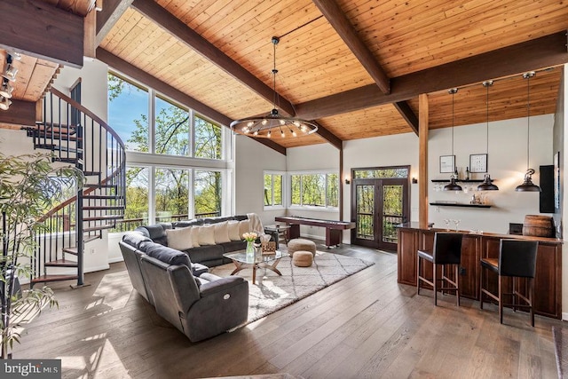 living room with wood ceiling, dark hardwood / wood-style floors, french doors, high vaulted ceiling, and beam ceiling