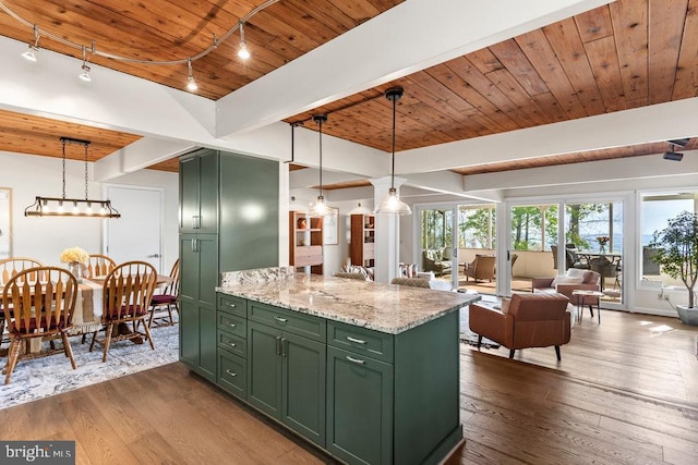 kitchen with light stone countertops, wood ceiling, pendant lighting, and green cabinetry