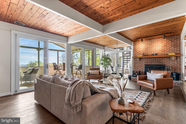 living room featuring french doors, a brick fireplace, a wealth of natural light, and hardwood / wood-style floors