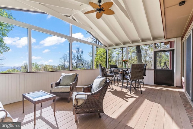 sunroom featuring ceiling fan and lofted ceiling with beams