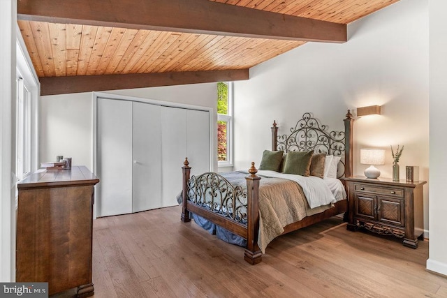 bedroom with wooden ceiling, a closet, wood-type flooring, and lofted ceiling with beams