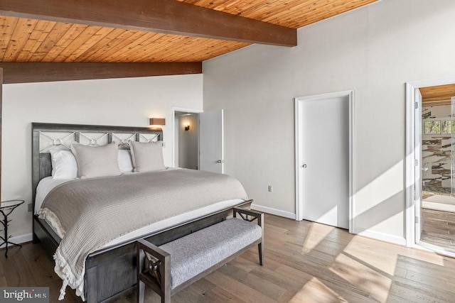 bedroom featuring vaulted ceiling with beams, wood-type flooring, wood ceiling, and connected bathroom