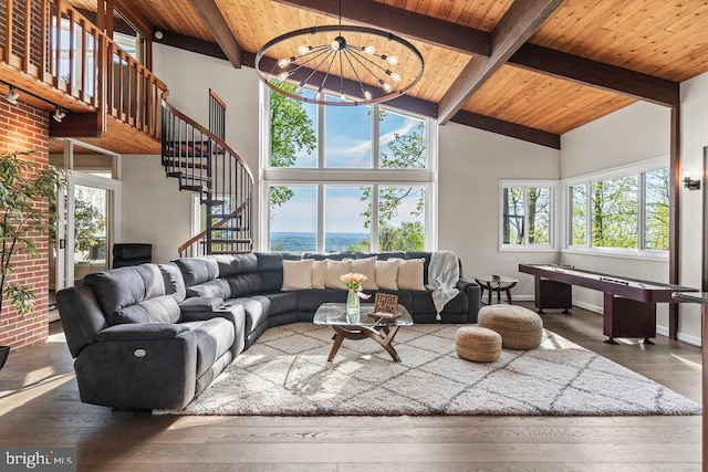 living room with wooden ceiling, dark hardwood / wood-style floors, high vaulted ceiling, a chandelier, and a water view