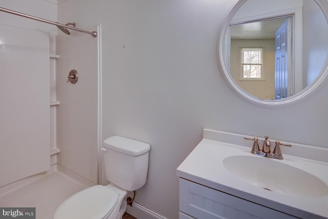 bathroom with vanity, toilet, and walk in shower