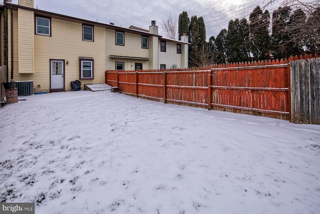 snowy yard with central air condition unit