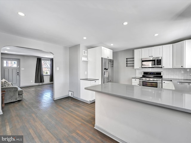 kitchen with sink, white cabinetry, decorative backsplash, and stainless steel appliances