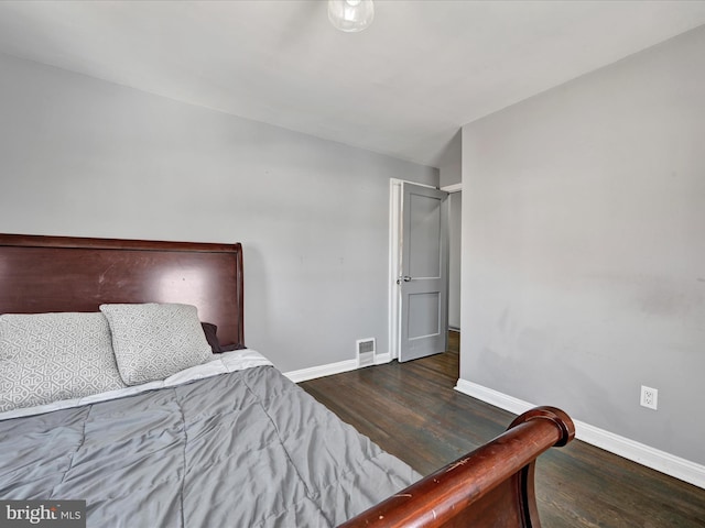 bedroom with dark wood-type flooring