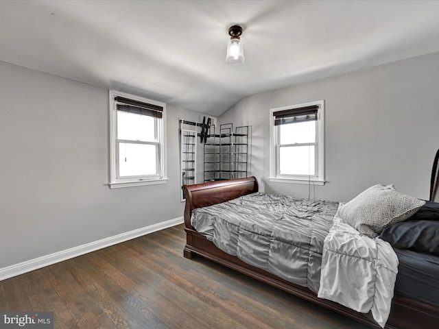 bedroom with dark hardwood / wood-style floors and vaulted ceiling